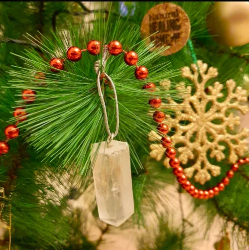 Clear quartz ornaments refracting colorful lights on a Christmas tree