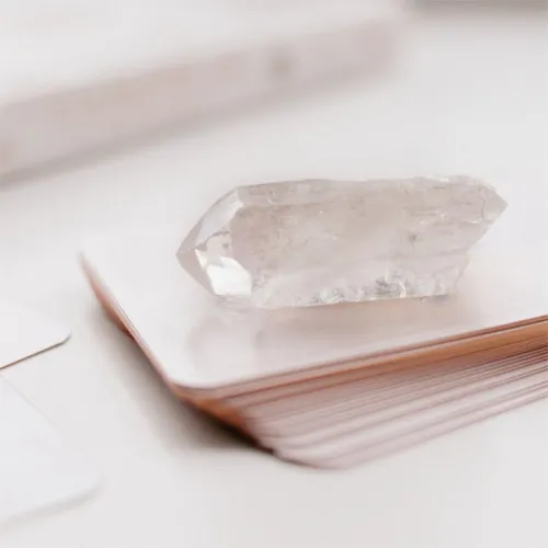 Clear quartz refracting sunlight on wooden surface