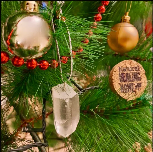 Frosted clear quartz sphere diffusing warm holiday lights on evergreen branches