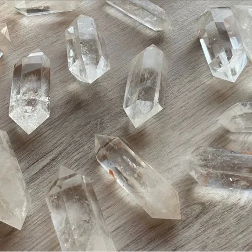 Jeweler inspecting gem using large clear quartz