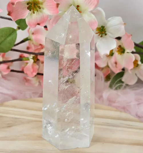 Person holding clear quartz contemplatively near window